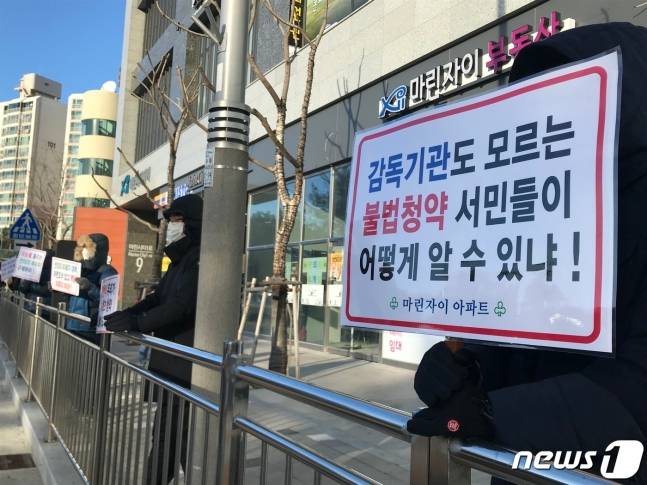 불법청약 분양권 전매로 계약취소 위기에 몰린 부산 해운대구 마린시티자이 아파트 입주민들이 선의의 피해자임을 호소하며 단지 앞에서 피켓 시위를 하고 있다. /사진제공=뉴스1