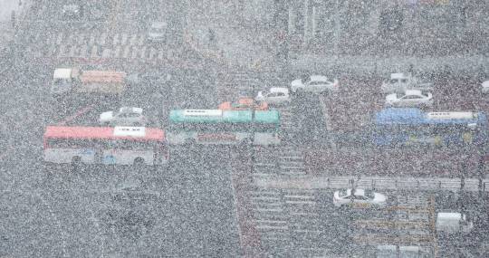 짙은 ‘눈발’에 가려진 거리 : 28일 오전 경기 고양시에 한 치 앞을 분간하기 힘들 정도로 폭설이 내리고 있는 가운데 차량들이 조심스럽게 운행하고 있다. 기상청은 서울과 경기 북부지역에 이날 오전 중 2시간 이내의 짧고 강한 눈이 내릴 것으로 예보했다. 연합뉴스