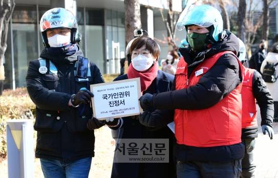 민주노총 서비스연맹 배달서비스지부 소속 회원들이 2일 서울 국가인권위원회 앞에서 베달라이더 무시하는 갑질아파트 문제해결요구 및 국가인권위 진정 기자회견을 마치고 인권위에 진정서를 제출하고  있다. 2021. 2. 2 정연호 기자 tpgod@seoul.co.kr