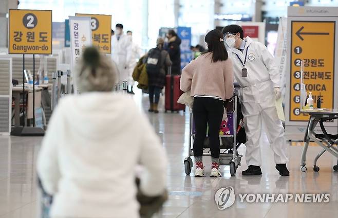 영국발 변이 바이러스 비상 (영종도=연합뉴스) 김도훈 기자 = 국내에서 영국발 코로나19 변이 바이러스 감염자가 추가로 확인되고 있는 가운데 6일 오전 인천국제공항 1터미널 입국장에서 방역 관계자들이 해외입국자들에게 식별 스티커를 부착해주고 있다. 2021.1.6 superdoo82@yna.co.kr