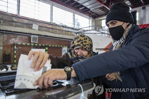 14일(현지시간) 실시된 코소보 조기 총선에서 한표를 행사하는 시민들.[AP=연합뉴스]