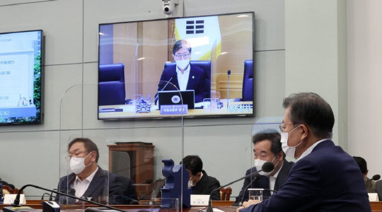 문재인 대통령이 16일 오후 청와대에서 화상회의 형식으로 열린 국토교통부 2021년 업무보고에서 변창흠 국토교통부 장관의 보고를 받고 있다. <연합뉴스>