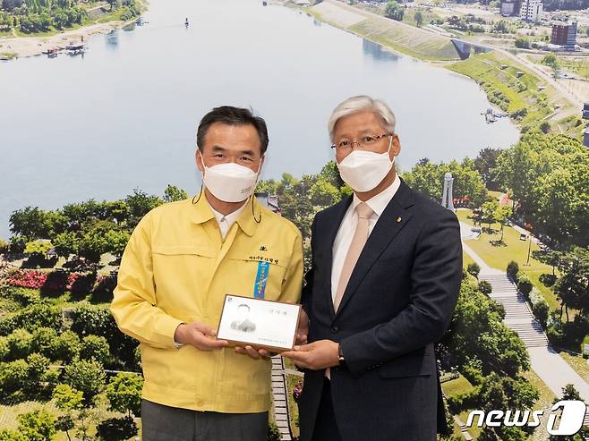 경기신용보증재단 이민우 이사장(오른쪽)이 이항진 여주시장에게 감사패를 전달했다.(경기신보 제공)/© 뉴스1