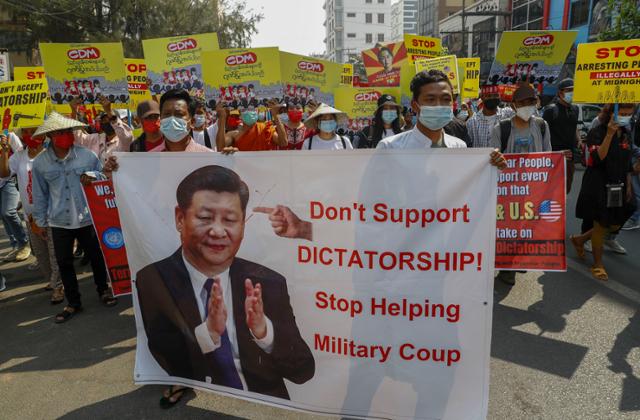 미얀마 제2의 도시 만달레이에서 17일(현지시간) 시위대가 시진핑 중국 국가주석의 사진을 들고 미얀마 군부 쿠데타에 대한 중국의 지원 중단을 촉구하고 있다. 중국은 오랜 기간 미얀마의 핵심 무기 공급처이자 투자자로서 미얀마 군부의 '뒷배'라는 의심을 사고 있다. 만달레이=AP연합뉴스