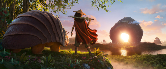 After losing her father, Raya spends her childhood roaming around the deserted lands in search of Sisu. with only her animal companion Tuk Tuk for company. [WALT DISNEY COMPANY KOREA]