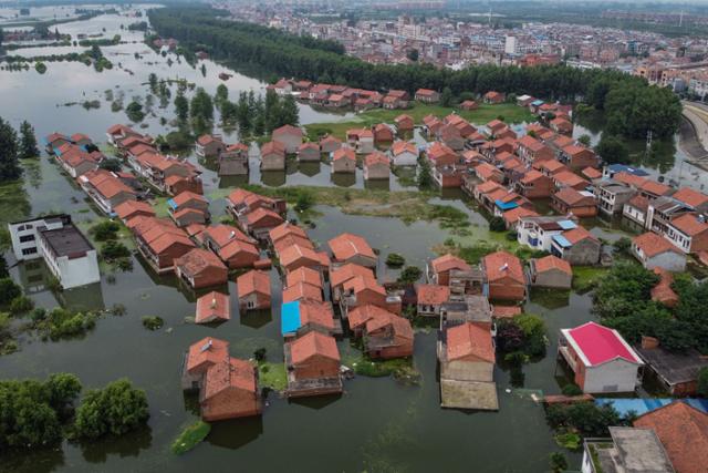 지난해 7월 중국 장시성 주쟝 인근을 흐르는 창장(양쯔강)의 수위 상승으로 현지 가옥들이 대거 물에 잠겨 있다. 주쟝=AFP 연합뉴스