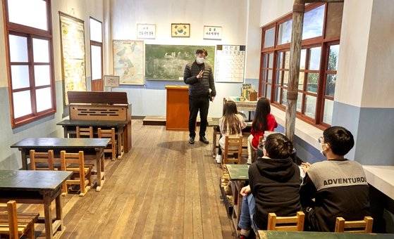 ‘서울학교 100년’ 전시를 둘러본 학생기자단이 김재경(왼쪽) 서울역사박물관 학예연구사의 설명을 듣고 있다.