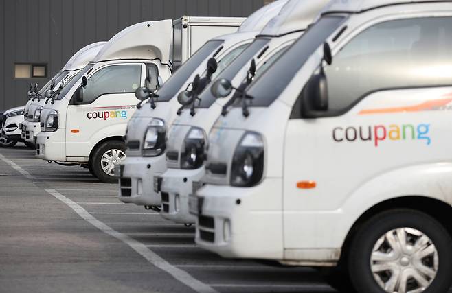 Coupang trucks are parked in a lot in Seoul. (Yonhap)