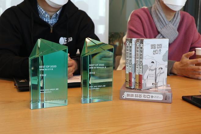 2019년 8월 출범한 만화경은 지난해 구글 플레이에서 ‘올해를 빛낸 인기앱 우수상’, ‘올해를 빛낸 엔터테인먼트 앱 우수상’을 수상했다. 오른쪽은 만화경 소속 키크니 작가의 ‘별일없이 산다’ 단행본. [우아한형제들 제공]