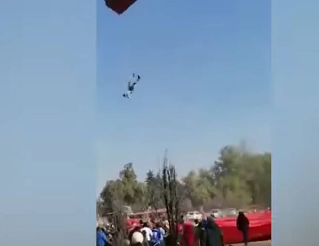 열기구에 매달린 남성이 거꾸로 된 채 추락하고 있다. [El Universal 영상 캡처]