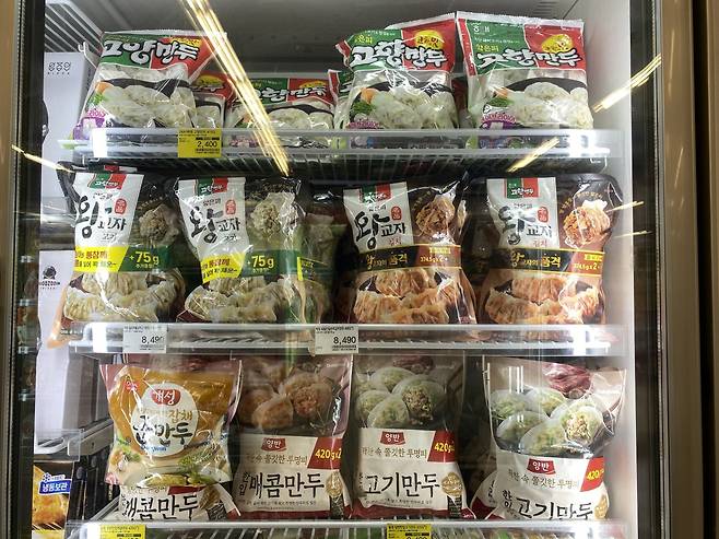 Frozen mandu displayed inside a refrigerator at a hypermarket. (Jo He-rim/The Korea Herald)