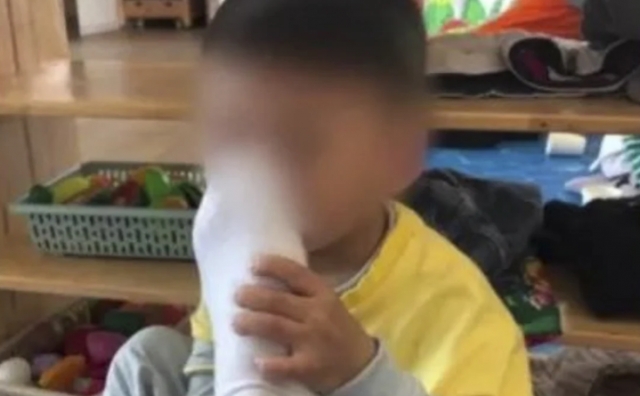 중국의 유치원 교사가 아이에게 강제로 발 냄새를 맡게 한 뒤 사진을 찍었다. SCMP