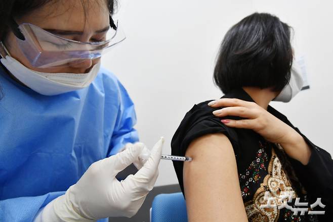 항공업계 종사자 대상 코로나19 백신 접종이 시작된 19일 오후 서울 강서구 부민병원에서 한 항공 운항 승무원이 아스트라제네카 백신을 접종하고 있다. 황진환 기자