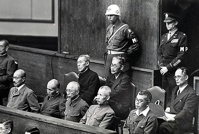 1946년 극동 국제군사재판(일명 도쿄전범재판) 법정에 앉아 있는 일본 A급 전범들의 모습이다. 이들은 1948년 11월 12일 징역 7년부터 사형에 이르는 중형을 선고받았다. 앞줄 왼쪽부터 도조 히데키 전 총리(사형), 오카 다카즈미 해군 중장(종신형), 우메즈 요시지로 육군 대장(종신형), 아라키 사다오 육군 대장(종신형), 무토 아키라 육군 중장(사형). 뒷줄 왼쪽 부터 하라누마 기이치로 전 총리(종신형), 도고 시게노리 외무대신(징역 20년), 시게미쓰 마모루 외무대신(징역 7년).