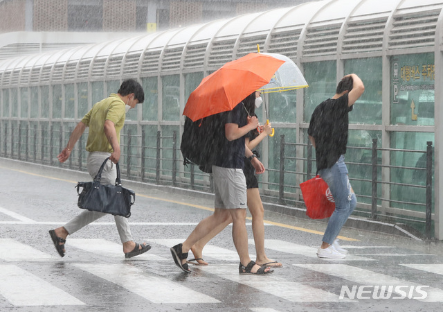 제주국제공항에서 관광객들이 비를 피해 렌터카 보관소로 뛰어가고 있다. 뉴시스DB