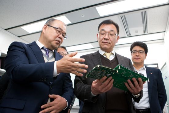 이효승 네오와인 사장(왼쪽)이 2018년 1월 회사를 방문한 김용수 과기정통부 차관에게 회사 제품을 설명하고 있다.