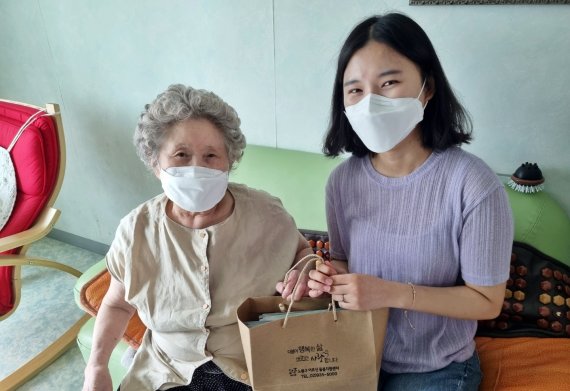 사회복지학과 학생이 지난 23일 노원구 독거노인 가정에 방문에 사랑의 죽과 방역물품을 전달하고 있다.