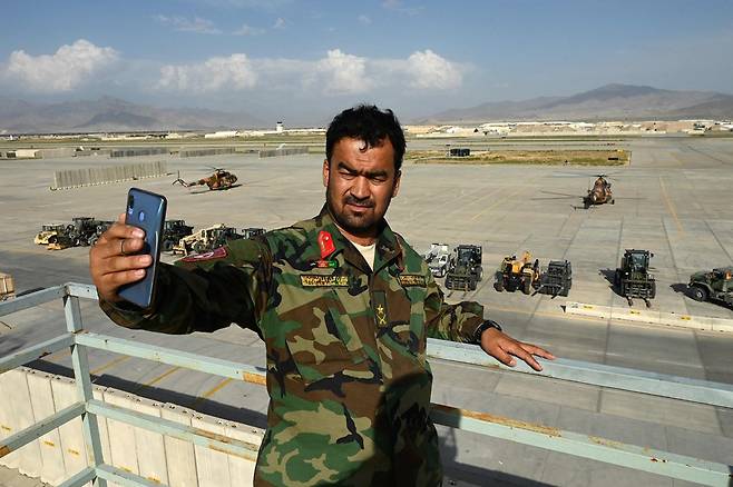 미군이 철수한 기지를 배경으로 셀카를 촬영중인 아프칸 군인. 사진=AFP 연합뉴스