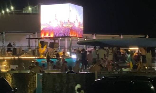 지난 17일 강원 양양군에 있는 한 리조트의 야외 수영장에서 수십명의 사람들이 마스크도 없이 한데 모여 춤을 추고 있다. 독자 제공