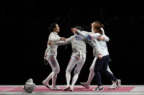 The Korean women's sabre team celebrate after winning the bronze medal against Italy at the Tokyo Olympics on Saturday at the Makuhari Messe Hall in Chiba, Japan. [JOINT PRESS CORPS]