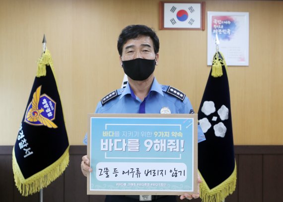 박형민 부산해양경찰서장이 SNS 릴레이 캠페인 '바다를 구해줘!' 바다사랑 실천운동에 동참한 후 기념사진을 찍고 있다. 부산해양경찰서 제공