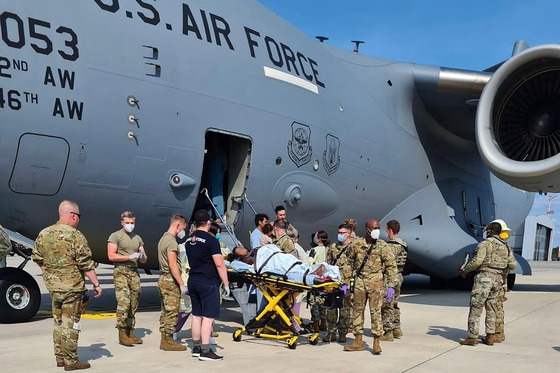 An Afghan mother who gave birth aboard a U.S. Air Force C-17 aircraft during an evacuation flight is transported to a nearby medical facility after landing at Ramstein Air Base in Germany Saturday. [U.S. AIR FORCE]