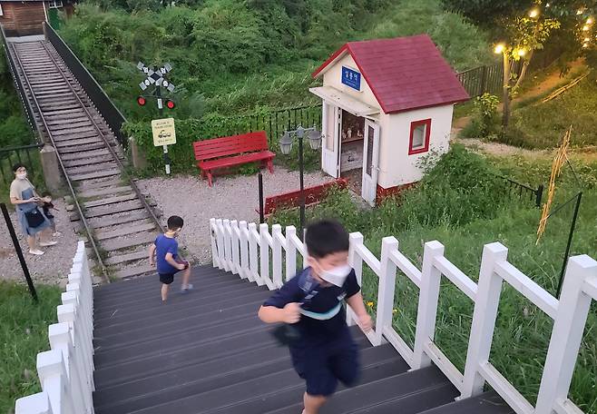설봉호변 설봉역 기찻길 놀이터에 아이들이 놀고 있다. 반대편에서 찍으면 나무데크 계단길도 기찻길 연결구간 처럼 보인다.
