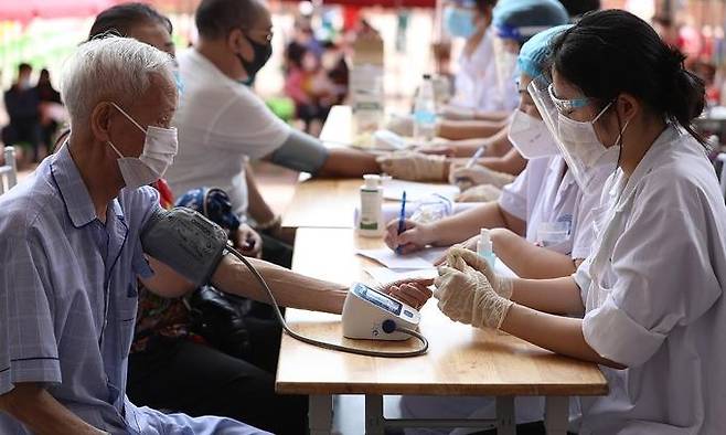 백신 접종에 맞서 혈압을 재고 있는 하노이 시민 [VN익스프레스 사이트 캡처. 재판매 및 DB 금지]