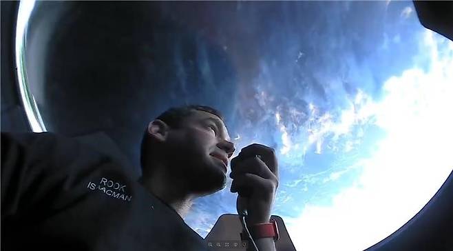 아이잭먼이 크루드래건의 투명돔인 큐폴라를 통해 지구를 보고있다
