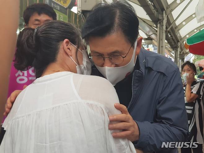 [대구=뉴시스] 정창오 기자=국민의힘 대선주자인 황교안 전 국무총리가 29일 오후 대구의 가장 큰 전통시장인 중구 서문시장을 방문해 시민과 귀엣말을 나누고 있다. 2021.09.29. jco@newsis.com