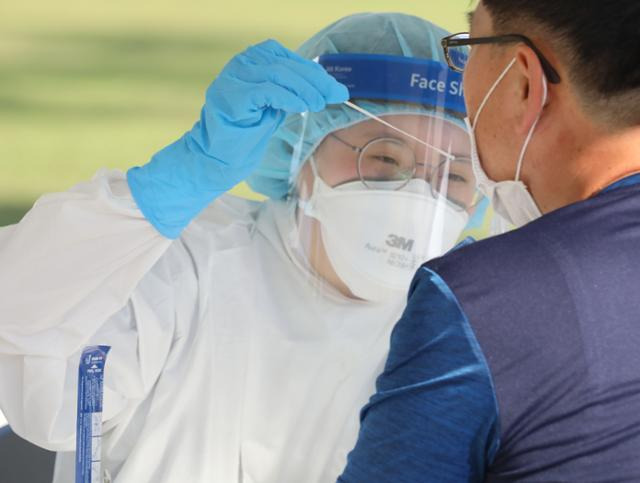 경북 구미시 낙동강체육공원에 설치된 코로나19 임시선별진료소에서 30일 한 시민이 코로나19 진단검사를 받고 있다. 뉴스1