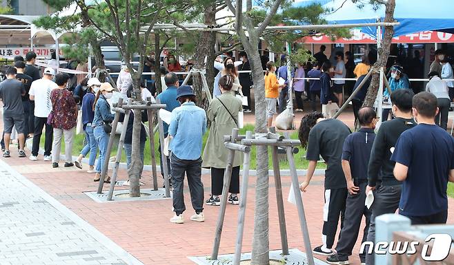 28일 대구지역 신종 코로나바이러스 감염증(코로나19) 확진자가 닷새째 100명대를 기록한 가운데 달성군보건소 선별진료소 앞에 지역 주민들과 외국인 근로자들이 줄지어 코로나19 진단검사를 기다리고 있다. 2021.9.28/뉴스1 © News1 공정식 기자