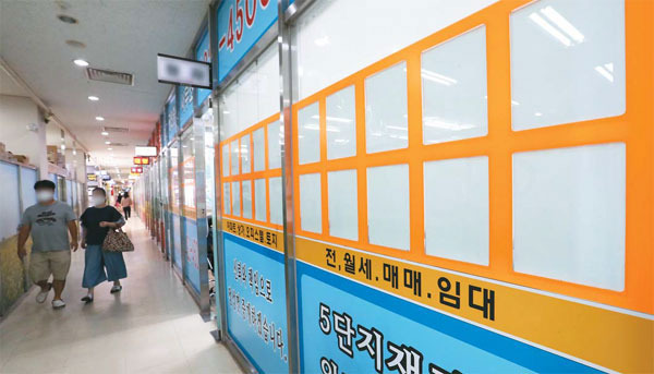 4일 서울 송파구 잠실동 리센츠 상가 중개업소 매물판에 매물 정보가 사라진 가운데 행인들이 지나가고 있다. 다주택자들이 정부보유세 강화에 대응해 증여를 서두르는 가운데 송파구는 지난 6월 아파트 증여가 전월 대비 역대 최고 수준인 7.7배나 폭증했다. [이충우 기자]
