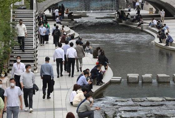14일 오후 서울 중구 청계천에서 직장인들이 점심시간을 이용해 휴식을 취하고 있다. 뉴스1