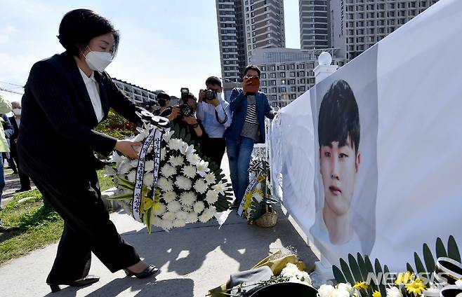 [여수=뉴시스] 변재훈 기자 = 심상정 정의당 대선후보가 14일 전남 여수시 웅천동 이순신마리나 요트정박장에서 잠수 작업 중 숨진 특성화고 실습생 고(故) 홍정운 군 사진 현수막 앞에 조화를 놓고 있다. 2021.10.14. wisdom21@newsis.com