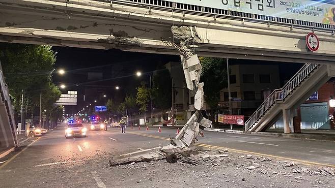 [광주=뉴시스] 변재훈 기자 = 18일 오전 4시30분께 광주 북구 북동 모 초등학교 앞 육교에 건설 중장비인 집게차가 충돌했다. 이 사고로 약 4.3m 높이 교량 하부 콘크리트 구조물이 파손돼 도로로 추락하고 일부 균열이 발생, 행정당국이 응급 복구에 나섰다. (사진=광주 북구 제공) 2021.10.18. photo@newsis.com *재판매 및 DB 금지