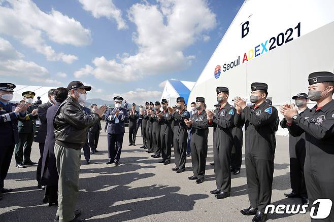 문재인 대통령이 20일 경기도 성남시 서울공항에서 열린 2021 서울 국제 항공우주 및 방위산업 전시회(ADEX) 개막 기념행사에 참석해 시범비행을 마친 공군 특수비행팀 블랙이글스 대원들을 격려하고 있다. 2021.10.20/뉴스1 © News1 이광호 기자