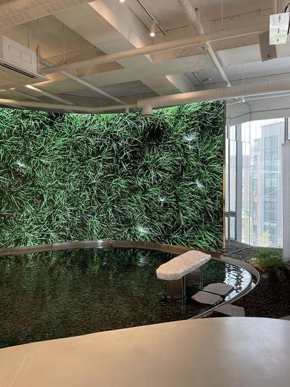 A large media wall is on display and visitors can sit on the stone chair in front of it. [LEE SUN-MIN]