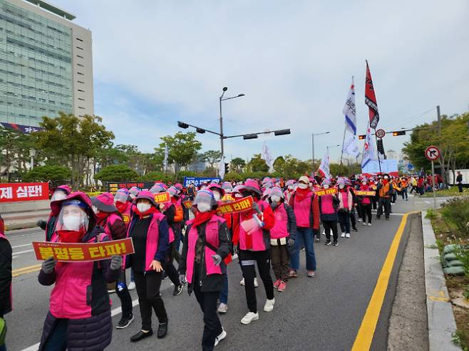 민주노총 광주본부 조합원들이 지난 20일 광주 서구 광주시청 앞에서 거리 대행진을 하고 있다. 김한영 기자