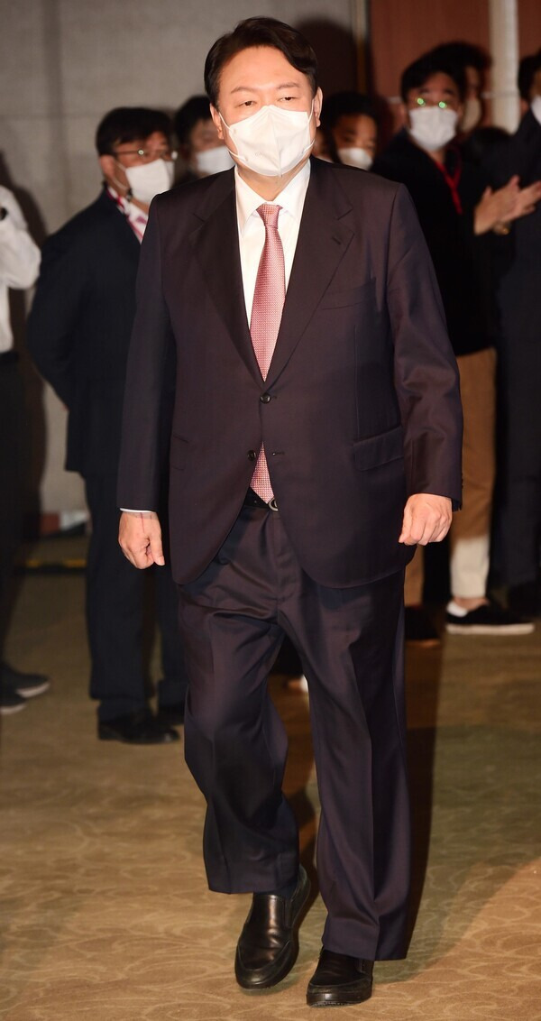 People Power Party presidential nominee Yoon Seok-youl heads to the stage during the party’s second national convention, held at the Kim Koo Museum and Library on Friday. (National Assembly pool photo)