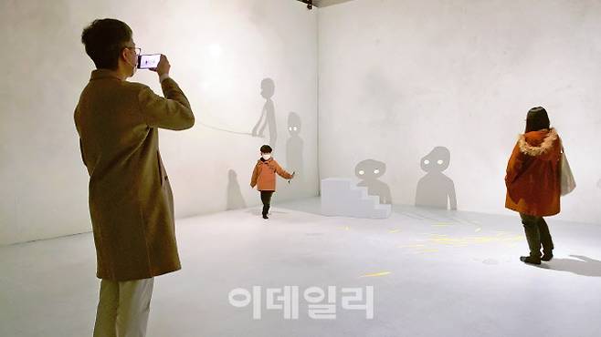 문준용의 미디어아트 ‘어그먼티드 섀도: 별을 쫓는 그림자들’에 참여한 관람객들. 부모와 함께 전시를 찾은 한 아이가 ‘그림자놀이’에 빠져 있다. 유독 가족단위 관람객이 많았던 전시다(사진=오현주 문화전문기자).