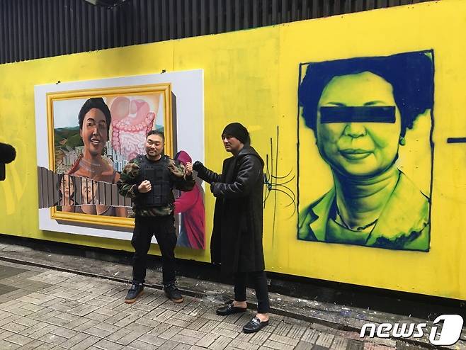 30일 서울시 종로구 관철동 중고서점 벽화 앞에서 닌볼트 작가와 뱅크시 작가가 포즈를 취하고 있다© 뉴스1