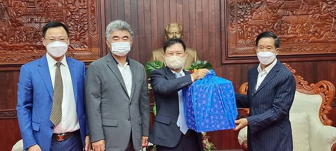 From left: Fu Jian, president of Wanfeng Property; Jung Won-ju, vice chairman of Jungheung Group; Yang Young-hwan, chairman of D&C Mineun; and Sinlavong Khoutphaythoune, president of the Lao Front for National Construction, pose for a photo during an event held at the Lao People’s Revolutionary Party in Vientiane, Laos. (Jungheung Group)