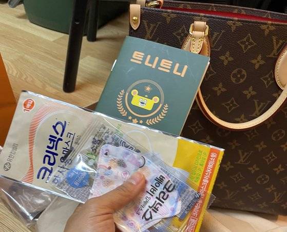 소비자 A씨가 명품 브랜드 루이뷔통에서 구매한 가방 속에 마스크 등 물건이 들어있었다며 판매 직원에게 항의하는 문자메시지를 보낸 캡처 화면. [제보자 제공]