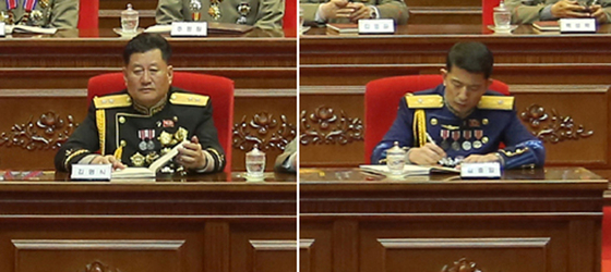 Photos of a weekend military meeting released on Tuesday by the North's state-run Korean Central News Agency show Navy Commander Kim Myong-sik, left, and Air Force Commander Kim Chung-il each sporting one less star on their epaulettes compared to their previous public appearances. [YONHAP]