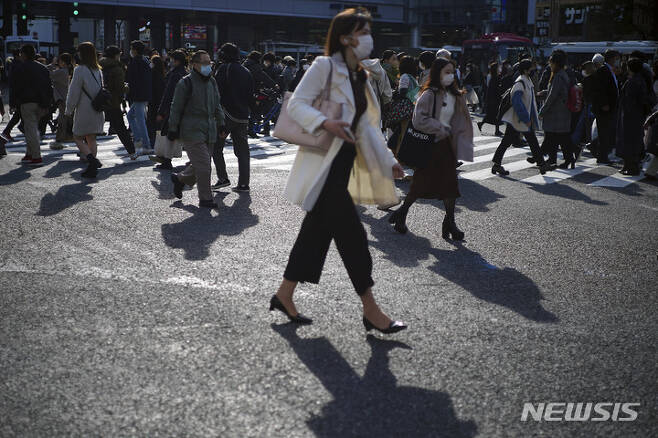 [東京(日本)=AP/ニューシース]10日日本東京澁谷の横断歩道を鼻でも19 感染予防のためにマスクを着した市民たちが渡っている. 2021.12.10.