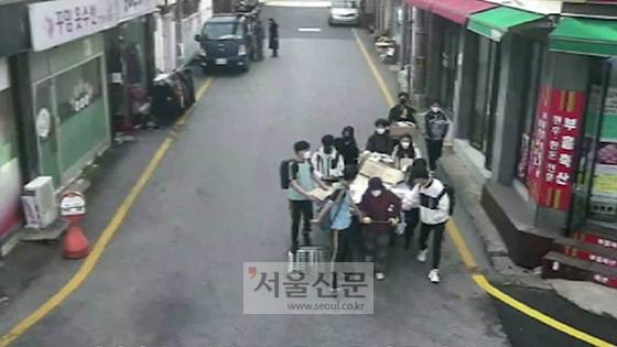 지난 15일 부산 망미중학교 학생들이 수레를 끄는 할머니를 돕고 있다. [사진 제공=부산 수영구청]