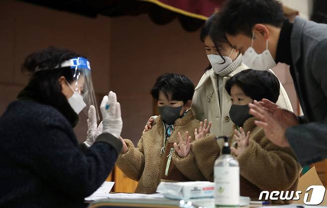 2022학년도 신입생 예비소집일인 5일 오후 서울 노원구의 한 초등학교에서 예비 초등학생과 학부모가 입학 절차를 마친 후 선생님과 인사를 나누고 있다. 2022.1.5/뉴스1 © News1 김진환 기자