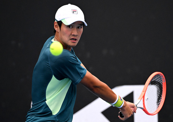 Kwon Soon-woo in action during his first round match against Denmark's Holger Rune on Monday at the Australian Open in Melbourne Park, Melbourne. [REUTERS/YONHAP]