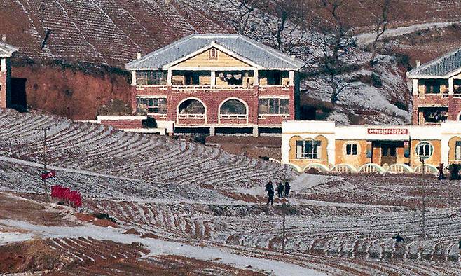 20일 경기도 파주시 오두산 통일전망대에서 바라본 북한 황해북도 개풍군에서 북한 주민들이 인공기와 붉은 깃발을 세운 들판에 모여 있다. 연합뉴스